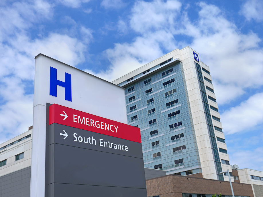 A hospital with an entrance and emergency sign